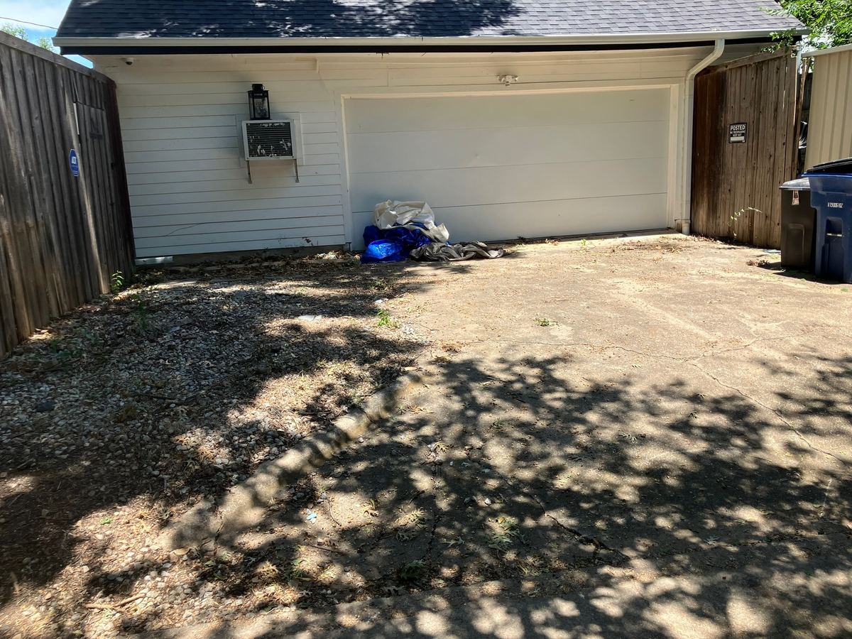 Same driveway and garage wall cleared after haul-away
